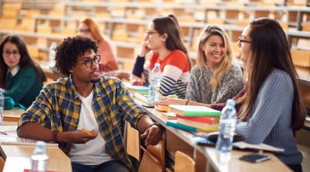 Young people talking in a lecture hall