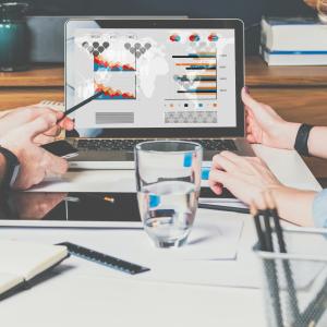 Two people working together at a laptop.