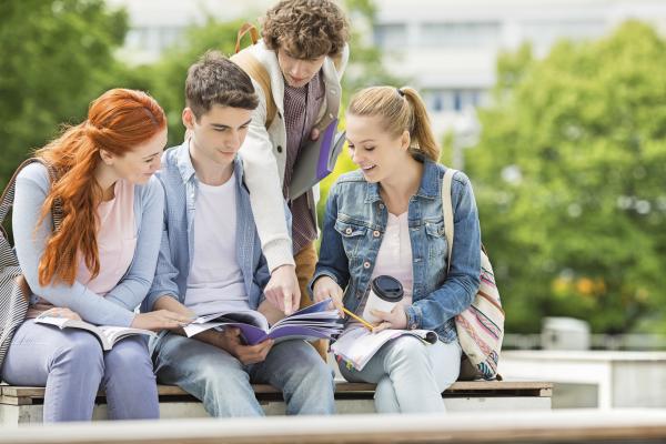 Group of students studying a document
