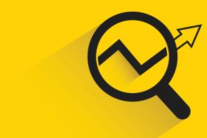 Magnifying glass examining an upward arrow